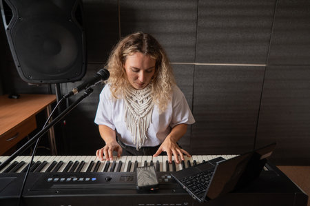 Caucasian woman singing into microphone and playing synthesizerの写真素材