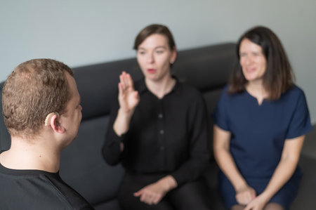 A man and two women are talking in Russian sign languageの写真素材