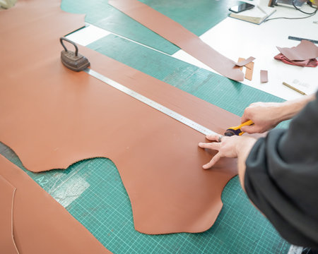 Bearded man working as a tanner in a workshop