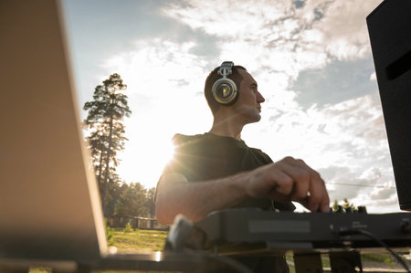 DJ works in the backyard of a country house