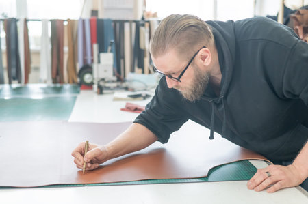 Caucasian bearded man working as a tanner in a workshop