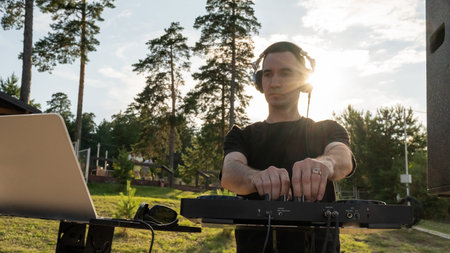DJ works in the backyard of a country house
