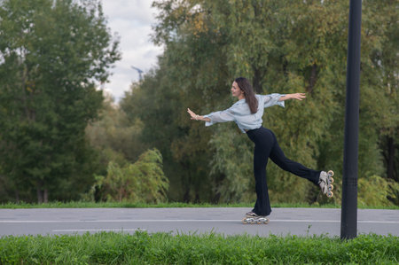 Caucasian woman roller skating in parkの写真素材