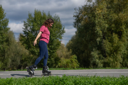 Caucasian woman roller skating in parkの写真素材