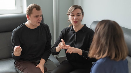 A man and two women are talking in Russian sign languageの写真素材
