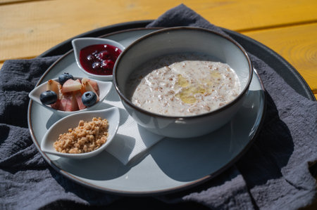 Reserved breakfast at a cafe. A plate of porridge on a table in a street cafeの写真素材