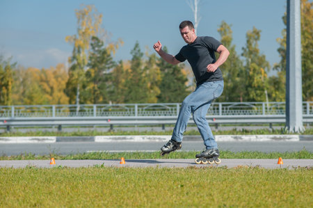 A Caucasian man rollerblades around the slalom course