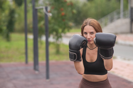 A Caucasian woman practices boxing outdoorsの写真素材