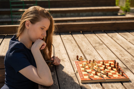 Caucasian woman playing chess outdoorsの写真素材