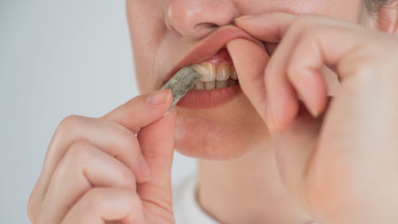 A woman uses chewing tobacco