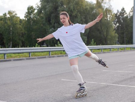 Caucasian woman in shorts roller skatingの写真素材