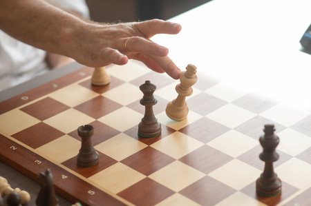 Close up of hands of middle aged man playing chessの写真素材