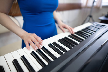 Caucasian woman playing electric pianoの写真素材