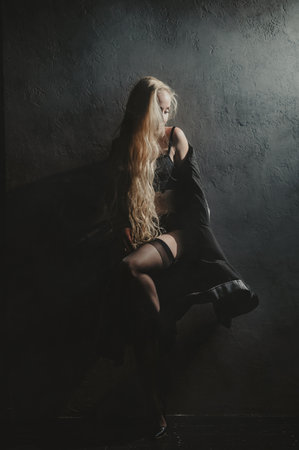 Long-haired blonde woman posing in lingerieの写真素材