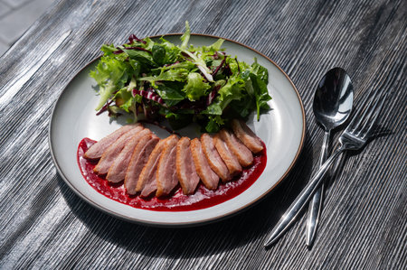 Roasted duck cut into pieces on a plateの写真素材