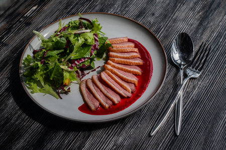 Roasted duck cut into pieces on a plateの写真素材