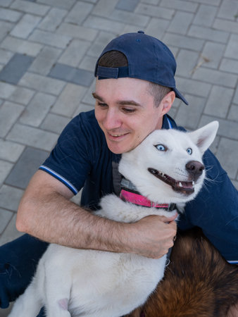 A man hugs his dog on a walk