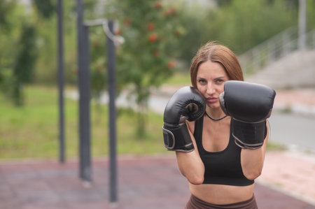 A Caucasian woman practices boxing outdoorsの写真素材