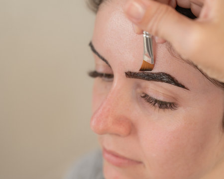 Caucasian woman getting eyebrow tinting procedureの写真素材