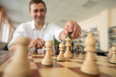 Caucasian man thinking about a chess moveの写真素材