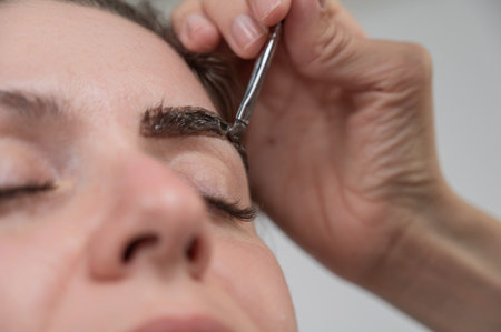 Caucasian woman getting eyebrow tinting procedureの写真素材