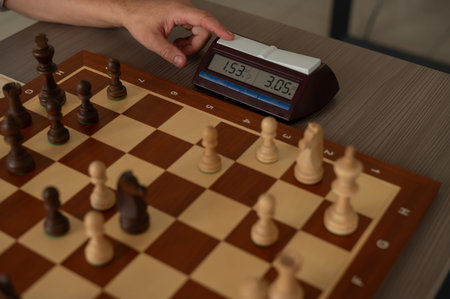 Close up of hands of middle aged man playing chessの写真素材