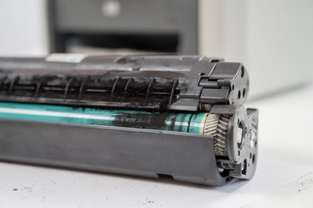 Broken laser printer cartridge on white background