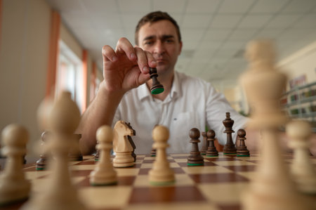 Caucasian man thinking about a chess moveの写真素材