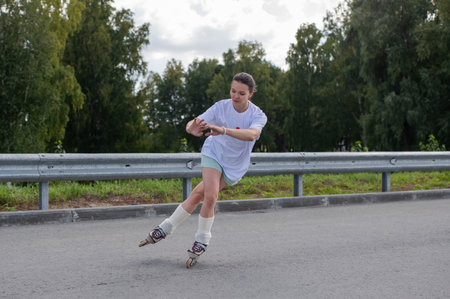 Caucasian woman rollerblading fast on roadの写真素材
