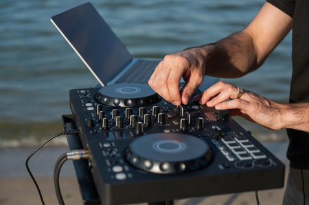 Close up of DJs hands while working outdoorsの写真素材