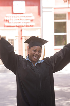 Portrait of happy african woman in graduation gown