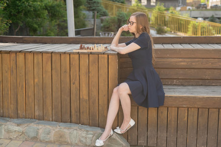 Caucasian woman playing chess outdoors