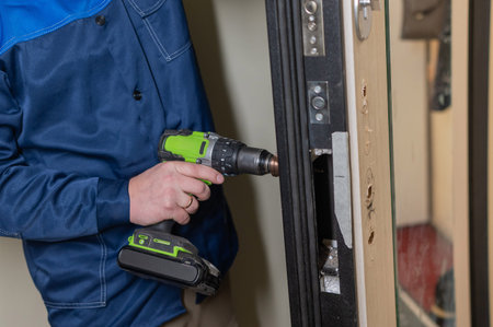 The technician installs a smart electronic lock on the front door
