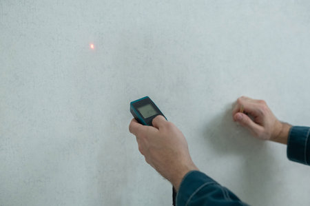 The master uses a laser tape measure
