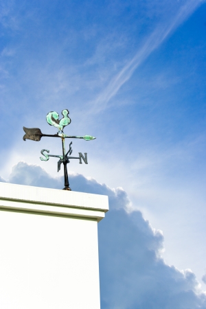 The vintage  wind cock direction on Blue sky cloud and sunlightの写真素材