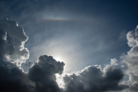 Blue sky cloud and sunlight with small rianbowの写真素材