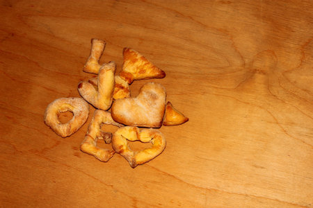 Cookies with the curly letters of the word love on a wooden backgroundの写真素材