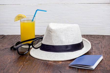glass of juice with a summer hat and sunglassesの写真素材
