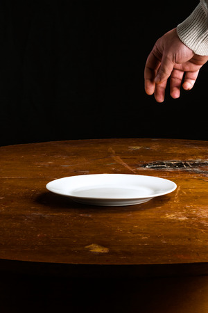hand over a blank plateの写真素材