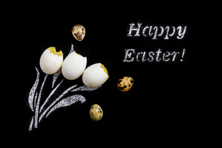 Easter eggs and flour in the form of a bouquet of tulips on a black background in the form of a...