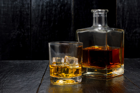 whiskey with a decanter on a wooden backgroundの写真素材