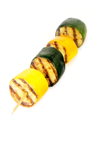 green and yellow zucchini grill on skewer on white background for isolationの写真素材