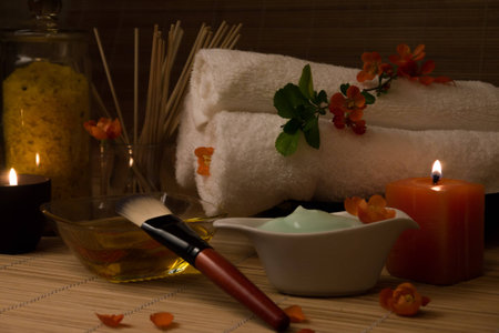 Close-up. Spa still life. Sea salt bath, massage oil, candles, flowers and towels. Body Cream. Japanese Flowers.の写真素材