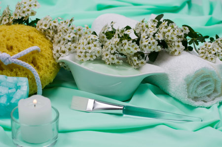 Close-up. Spa Still Life. At the Turquoise Fabrics. Burning Candle. Sponge. Natural flowers. Towel. Handmade Soap.の写真素材