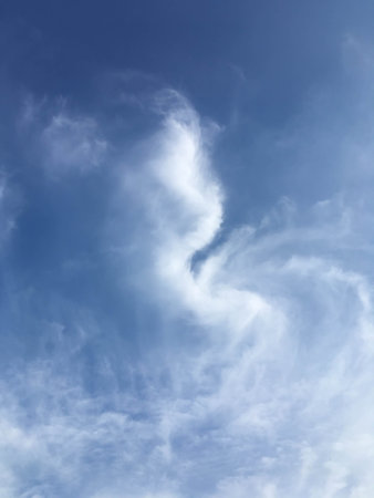 cloudy in spiral shape on blue skyの写真素材