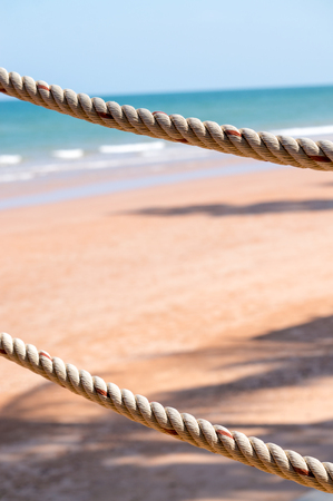 rope of fence and sea backgroundの写真素材