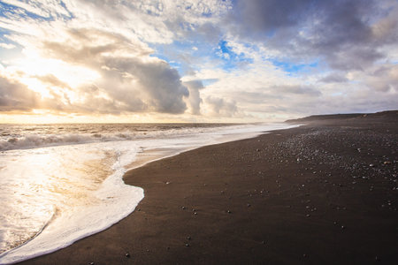 Black lava beach in the south of Iceland at sunsetの写真素材