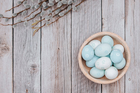 Easter decorations. Easter eggs dyed with pastel colors, bowl, on wooden backgroundの写真素材