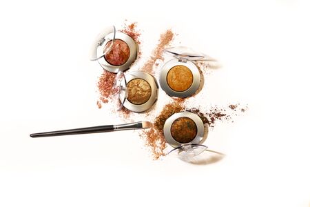 Shimmery and glittery eye shadow compacts isolated on white background with applying brushの写真素材