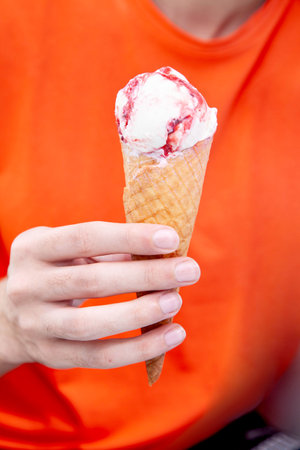 Hand holding gelato cone ice cream in two handsの写真素材